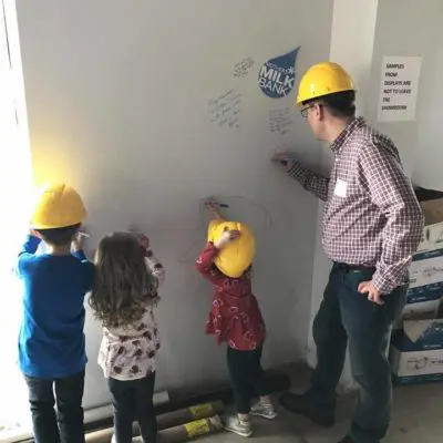 Children signing wall at Mother's Milk Bank groundbreaking