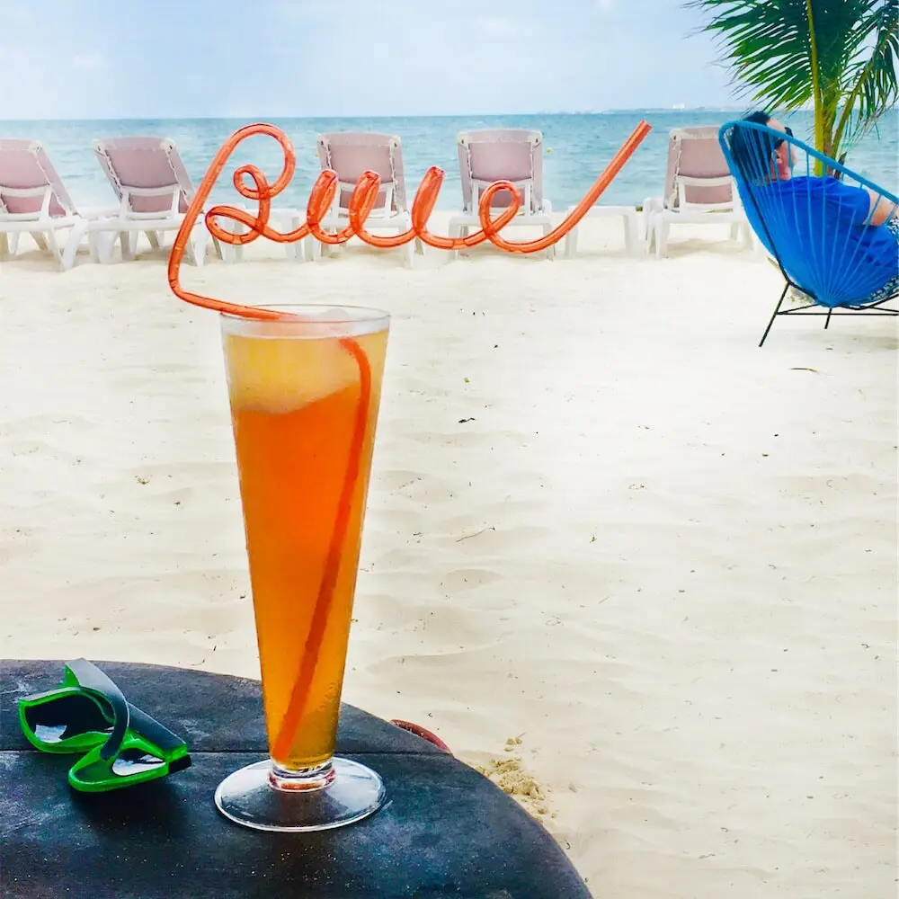 Buie straw in cocktail on beach