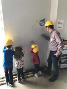 Children signing wall at Mother's Milk Bank groundbreaking