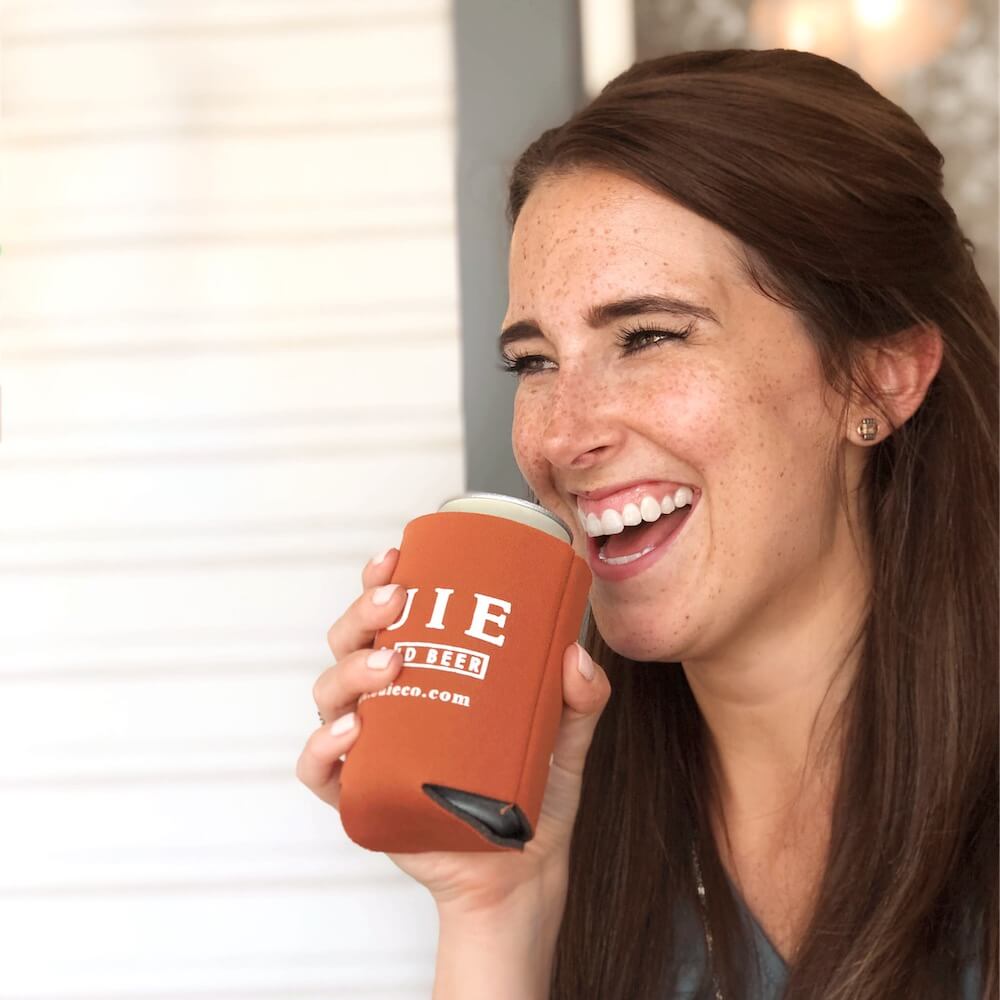 Woman drinking from buie koozie